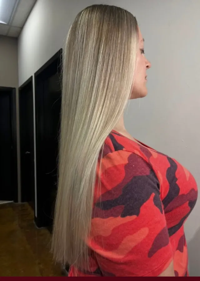 Very long, sleek, cool-toned blonde highlights with a smooth straight finish.