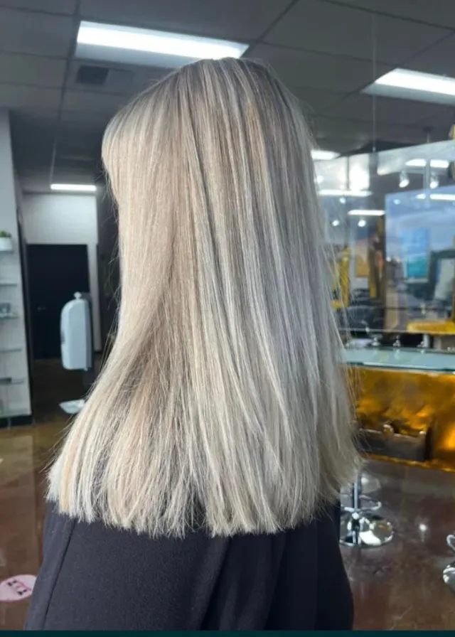 Bright platinum-blonde hair in a blunt lob.