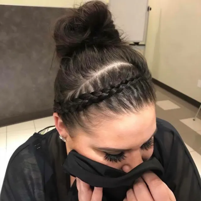 A high bun finished with a wrapped accent braid.